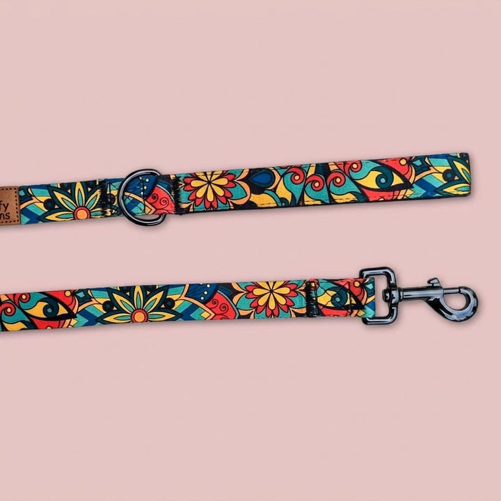 On aperçoit le mousqueton et le système d'attache de la laisse Mandala de la marque Goofy Goldens aux couleurs vertes, rouges, jaunes et bleues