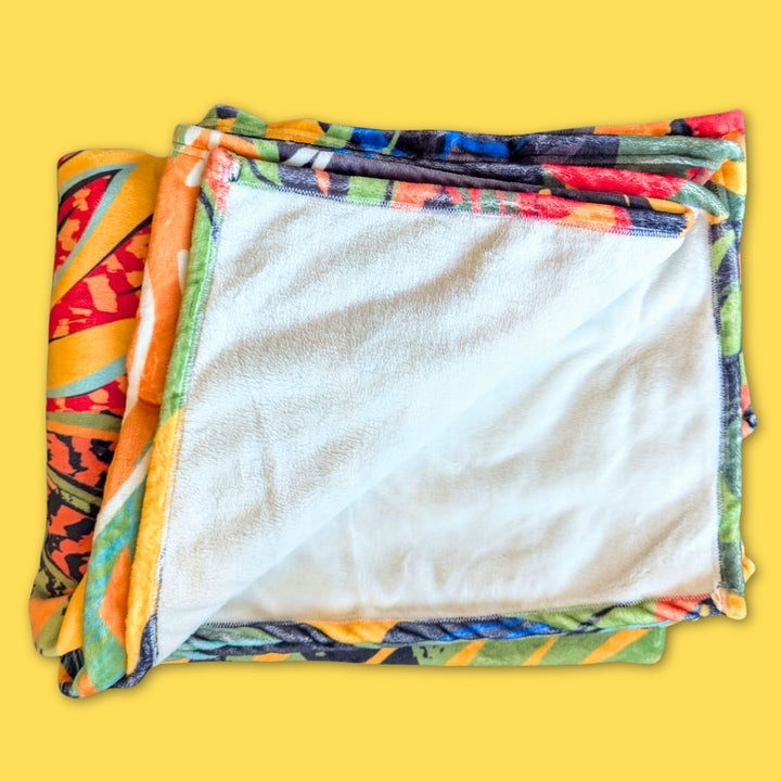 Plaid Tropical en polaire dense, ultra doux pour une chaleur maximale.